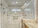 Large walk-in shower with glass enclosure and built-in shelving at 9719 Pleasant Run Way, Tampa, FL 33647