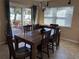 Bright dining room features a wood table with six chairs and sliding glass doors leading to the patio at 10373 137Th Ln, Largo, FL 33774