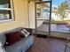 Relaxing screened porch with gray couch and brick patio at 10373 137Th Ln, Largo, FL 33774