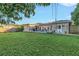 Backyard view showing large grassy area and deck at 323 30Th N Ave, St Petersburg, FL 33704