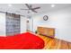 Bedroom with hardwood floors, red bedding, and sliding barn door at 323 30Th N Ave, St Petersburg, FL 33704