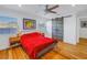 Bedroom with red bedspread, wood floors, and barn door at 323 30Th N Ave, St Petersburg, FL 33704