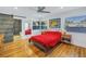 Bright bedroom with hardwood floors, red bedding, and barn door at 323 30Th N Ave, St Petersburg, FL 33704