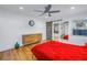 Bedroom with red duvet, wood floors, barn door to bathroom at 323 30Th N Ave, St Petersburg, FL 33704