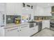 Bright kitchen with white cabinets, quartz countertops, and a farmhouse sink at 323 30Th N Ave, St Petersburg, FL 33704