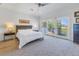 Main bedroom with king-size bed, sliding doors to balcony, and water views at 158 Ramon Ne Way, St Petersburg, FL 33704