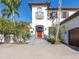 Front view of home with wood door and brick pavers at 158 Ramon Ne Way, St Petersburg, FL 33704