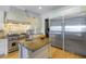 Modern kitchen with stainless steel refrigerator and granite island at 158 Ramon Ne Way, St Petersburg, FL 33704