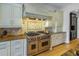High-end kitchen with professional range and custom hood at 158 Ramon Ne Way, St Petersburg, FL 33704