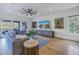 Open living room with hardwood floors, large TV, and ample natural light at 158 Ramon Ne Way, St Petersburg, FL 33704