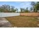 Private backyard with a white vinyl fence and a stucco wall at 1613 Prowmore Dr, Brandon, FL 33511
