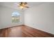 Bright bedroom with wood-look floors, ceiling fan and arched window at 1613 Prowmore Dr, Brandon, FL 33511