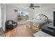 Spacious bedroom with a large bed, a ceiling fan, and a seating area at 1613 Prowmore Dr, Brandon, FL 33511