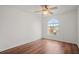 Bright bedroom with wood-look floors, ceiling fan, and large window at 1613 Prowmore Dr, Brandon, FL 33511