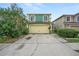 Two-story house with green exterior, attached garage, and landscaping at 1613 Prowmore Dr, Brandon, FL 33511
