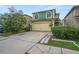 Two-story house with green exterior, attached garage, and landscaping at 1613 Prowmore Dr, Brandon, FL 33511