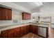Kitchen with wood cabinets, granite counters, and stainless steel sink at 1613 Prowmore Dr, Brandon, FL 33511