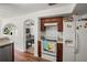 Kitchen features wood cabinets, an electric stove, and a view into the living room at 1613 Prowmore Dr, Brandon, FL 33511