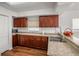 Kitchen with dark wood cabinets, granite countertops, and stainless steel appliances at 1613 Prowmore Dr, Brandon, FL 33511