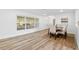 Bright dining room with wood-look floors and a table for four at 523 Deville E Dr, Largo, FL 33771