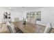 Spacious dining room with large wood table and neutral chairs at 523 Deville E Dr, Largo, FL 33771