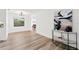 Light and airy entryway with wood-look floors and modern console table at 523 Deville E Dr, Largo, FL 33771