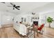 Open living room featuring a fireplace, hardwood floors, and adjacent dining area at 523 Deville E Dr, Largo, FL 33771