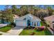 Single-Gathering home with a two-car garage and lush landscaping at 11220 Paradise Point Way, New Port Richey, FL 34654