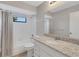 Clean bathroom with granite countertop and bathtub at 3117 S Canal Dr, Palm Harbor, FL 34684