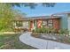 Brick ranch home with landscaped yard and curved walkway at 3407 King George Ln, Seffner, FL 33584