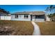 Charming bungalow with gray exterior, white trim, and a walkway at 4051 30Th N Ave, St Petersburg, FL 33713