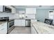 Renovated kitchen with white cabinets, granite counters, and stainless steel appliances at 4051 30Th N Ave, St Petersburg, FL 33713