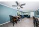 Open living room and kitchen area, featuring a sectional sofa and wood-look tile floors at 4051 30Th N Ave, St Petersburg, FL 33713