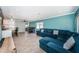 Open living area with sectional sofa, wood-look floors, and views into the kitchen and dining area at 4051 30Th N Ave, St Petersburg, FL 33713
