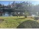 This backyard view features a tranquil pond and lush lawn with local wildlife, enhancing the property's charm at 1105 Savannah Landings Ave, Valrico, FL 33596