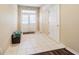 Inviting foyer with white tile flooring, complemented by a decorative light fixture and convenient coat closet at 1105 Savannah Landings Ave, Valrico, FL 33596