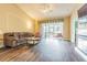 Comfortable living room featuring wood floors, a fireplace, and a sliding glass door leading to the outdoor space at 1105 Savannah Landings Ave, Valrico, FL 33596