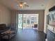 Inviting living room features sliding glass doors to a screened lanai and wood-look flooring at 1105 Savannah Landings Ave, Valrico, FL 33596