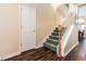 Elegant staircase with wood floors, leading to the upper level, with an adjacent closet and a dining area at 1105 Savannah Landings Ave, Valrico, FL 33596