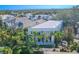 Aerial view of a modern white house with a flat roof, surrounded by lush tropical landscaping at 2711 W Trilby Ave, Tampa, FL 33611