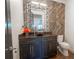 Elegant powder room with dark vanity and geometric tile at 2711 W Trilby Ave, Tampa, FL 33611