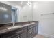 Double vanity bathroom with dark brown cabinets and granite countertop at 2711 W Trilby Ave, Tampa, FL 33611