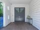 Modern front entrance with gray double doors and a contemporary console table at 2711 W Trilby Ave, Tampa, FL 33611