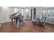 Living room with hardwood floors, grand piano, and comfortable seating at 2711 W Trilby Ave, Tampa, FL 33611