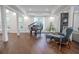 Bright living room featuring hardwood floors, a grand piano, and comfortable seating at 2711 W Trilby Ave, Tampa, FL 33611