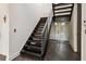 Modern dark wood staircase with glass and metal accents at 2711 W Trilby Ave, Tampa, FL 33611