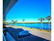 Waterfront parking area with a car and tropical trees at 611 Destiny Dr # 207, Ruskin, FL 33570