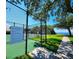 Tennis and pickleball courts with waterfront views at 611 Destiny Dr # 207, Ruskin, FL 33570