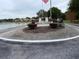 Heather Sound community entrance with a flag and lake view at 9107 Lingrove Rd, Weeki Wachee, FL 34613