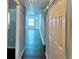 Bright hallway with dark floors and access to other rooms at 9107 Lingrove Rd, Weeki Wachee, FL 34613